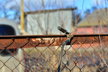 welder makes a fence in the street. Electric welder makes the fence in his own manor