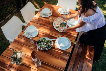 Woman setting food on table for housewarming