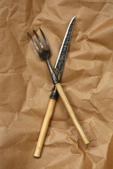 tableware, decoration, restaurant concept. top view of original and good looking silverware, a knife and a fork for salad, that have natural wooden handles