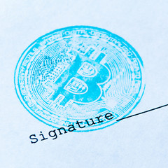 Macro. Square picture. The concept of any virtual financial document with a crypto currency. Blue bitcoin stamp and signature on a white sheet of paper. Close-up.