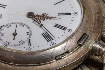 Close-Up of antique pocket-watch on the rustic desk