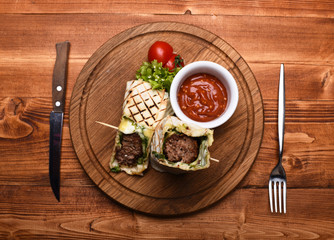 Flatbread with pork or chicken filling and red chili sauce