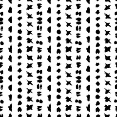 Grunge tribal seamless vector pattern. White background. Hand drawing ethnic design elements. Ink brush strokes. Dotted, spots, triangles, ovals, circles, sticks and crosses