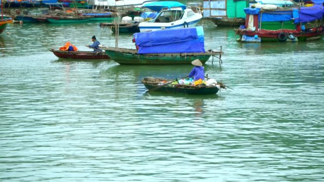 Cat Ba. the fishing village. View from the boat. A large number of traditional fishing boats around the station. The village in Vietnam. The island in Vietnam. Boats on pier.