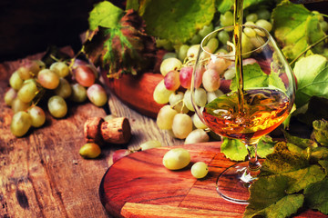 Cognac Pour In Glass, Grapes And Vine, Vintage Wood Background, Selective Focus