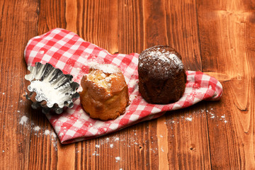 Composition of chocolate and vanilla cupcakes with sugar powder
