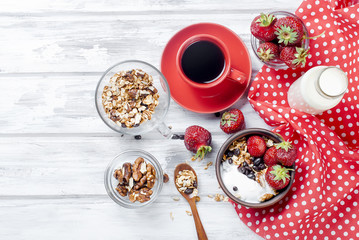 Obraz na płótnie Canvas Breakfast granola, strawberry and a cup of coffee