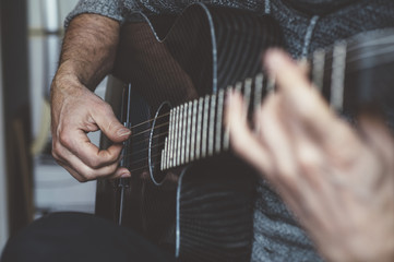 Elderly man playing carbon fiber guitar