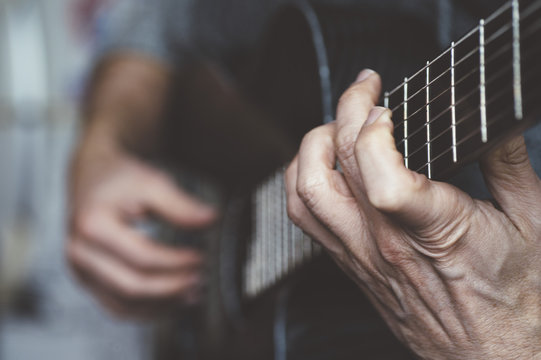 Elderly man playing carbon fiber guitar