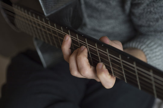 Elderly man playing carbon fiber guitar