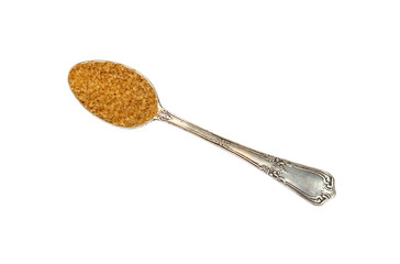 Vintage metal spoon full of brown cane sugar