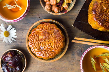 Chinese mooncake with tea,hazelnut, and arabic date served on wo