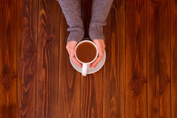 Cups of tea in the hands of men and women. Selective focus.
