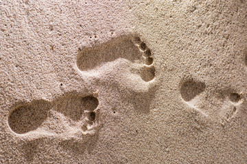 Human footprints on the sand beach. Travel vacations concept.