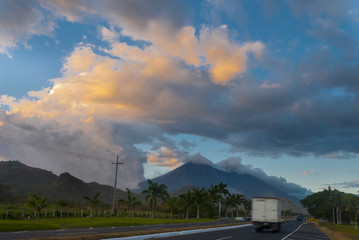 Fototapeta na wymiar Sunset on highway with view of volcanoes Fuego y Acatenango in Palin, Guatemala.