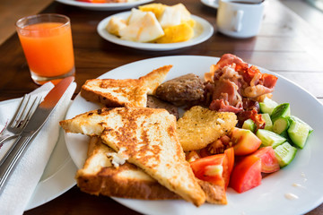 Plate with tasty toasts, meat and vegetables