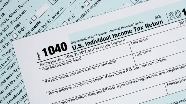 Slow rotation of macro close up of 2017 IRS form 1040