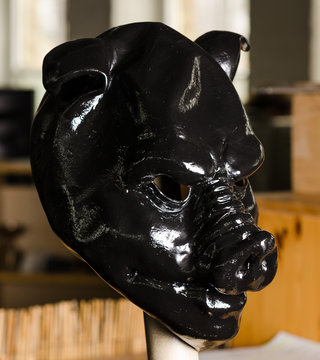 slick oily black pig mask painted in shiny latex black
