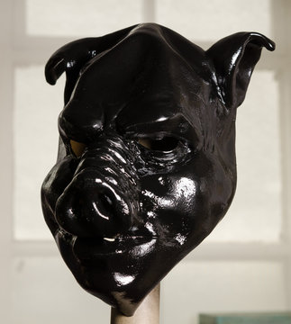 slick oily black pig mask painted in shiny latex black