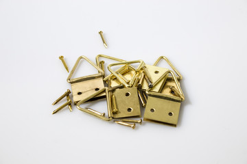 Gold tacks and hang up paintings in a white background