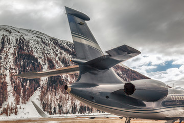 A view of a tail of a private jet in the alps