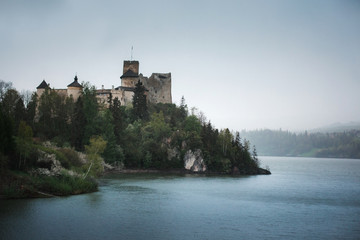 Fototapeta na wymiar Medieval castle on the hill by the lake. Niedzlica , Poland
