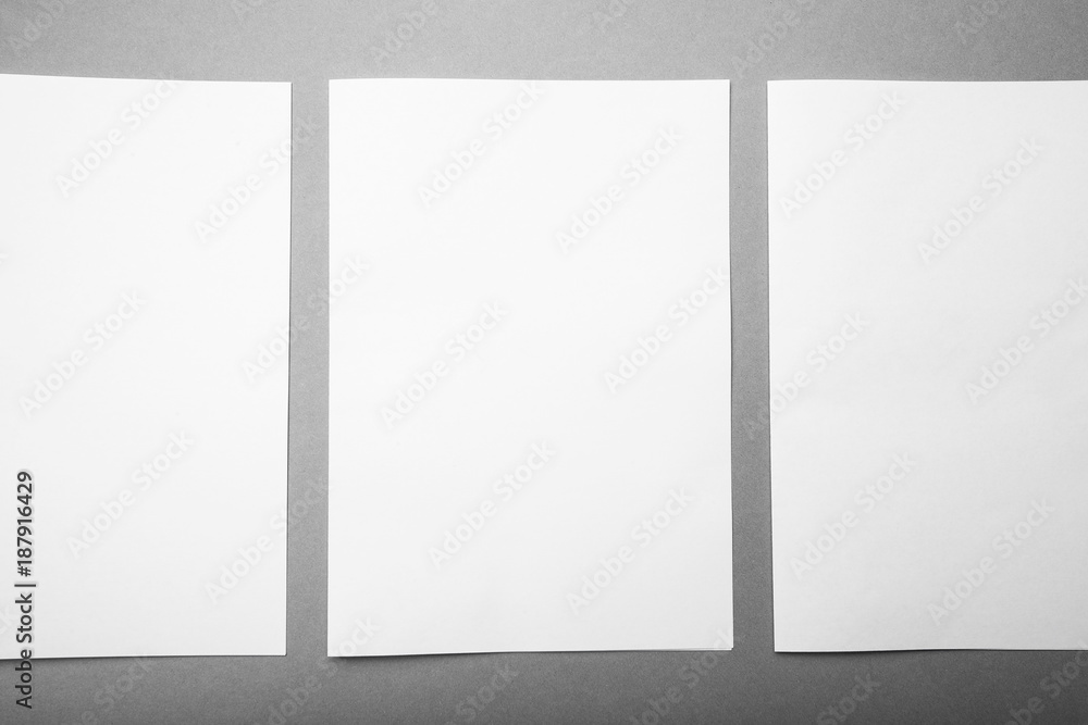 Poster three white sheets of a4 format in a row on a gray background, design options. mock-up.