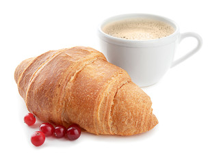 Yummy fresh croissant with cranberry and cup of coffee on white background