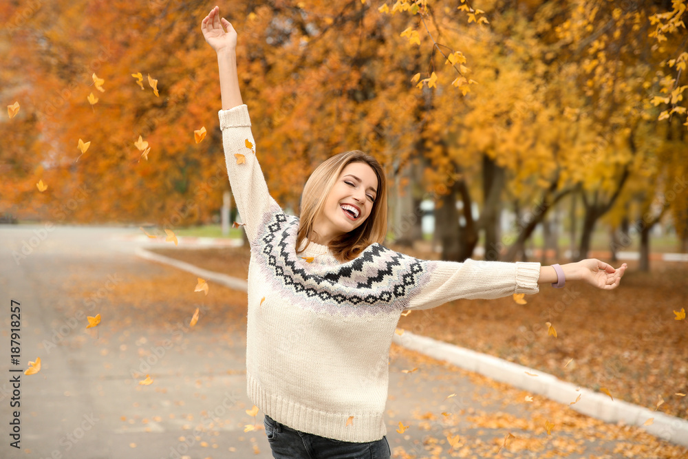 Wall mural beautiful smiling woman in autumn park