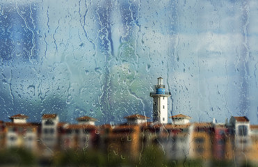 Raindrops on window, lighthouse