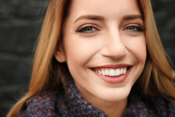 Fototapeta premium Beautiful smiling woman on dark background