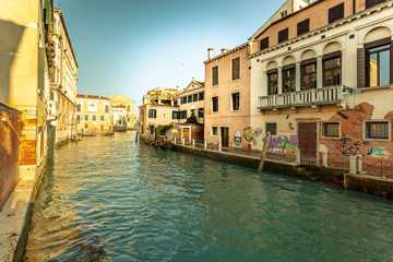Fototapeta na wymiar VENICE, ITALY - JANUARY 02 2018: Venetian canal with colorful houses