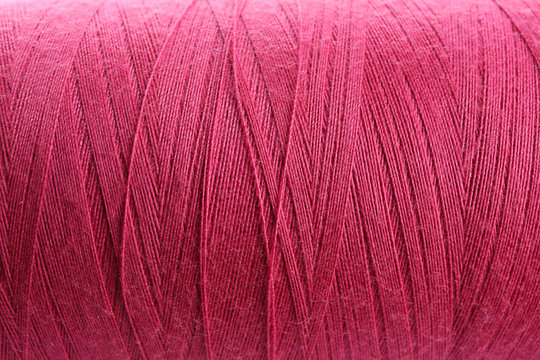 Pink thread bobbin, closeup
