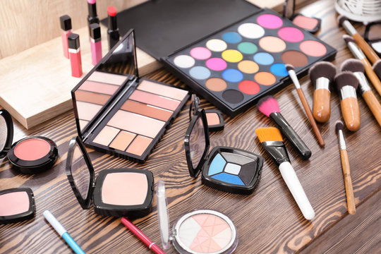 Decorative cosmetics and tools of professional makeup artist on dressing table
