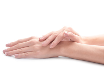 Young woman touching her hand and feeling moisturizing effect of cream on white background