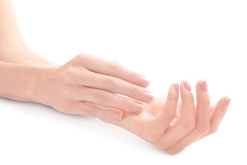 Young woman touching her hand and feeling moisturizing effect of cream on white background