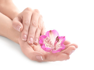 Young woman touching her hand and feeling moisturizing effect of cream on white background