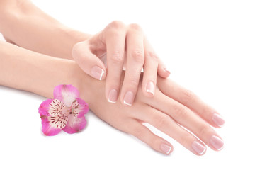 Young woman touching her hand and feeling moisturizing effect of cream on white background