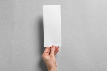 Woman holding blank card on light background. Mock up for design