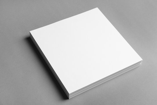 Blank sheets of paper on grey background. Mock up for design