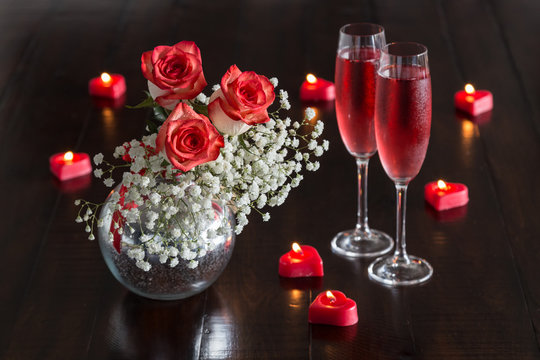 Romantic bouquet of blush roses, Rose champagne and heart shape Candles on the rustic  table.