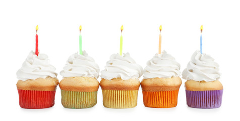 Birthday cupcakes with candles on white background
