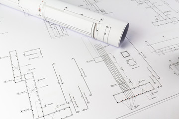 Building design: Office desk with project drawings