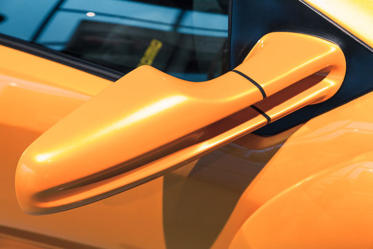 Luxury yellow sports car mirror, close-up © evannovostro