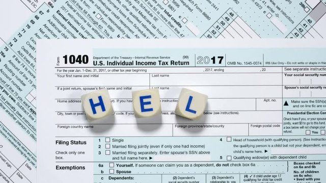 Macro close up of 2017 IRS form 1040 with word HELP