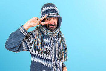 Man with winter clothes dancing on colorful background