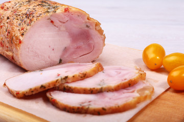 Homemade meatloaf from pork meat with spices on cutting board.