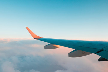 Fototapeta premium Golden light hitting the aircraft wing in flight.