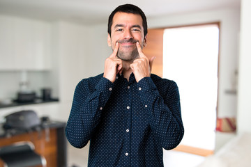 Happy handsome man inside house