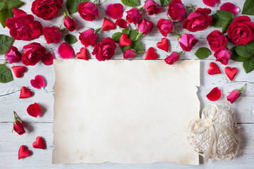 Roses and red hearts on a wooden background for Valentine's Day